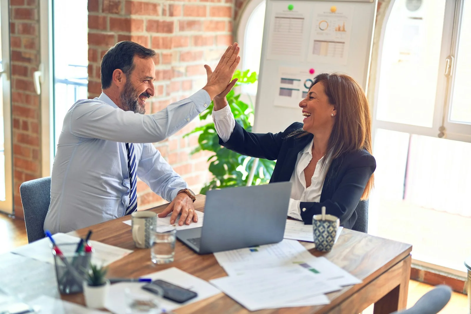 Business partners celebrating successful corporate collaboration